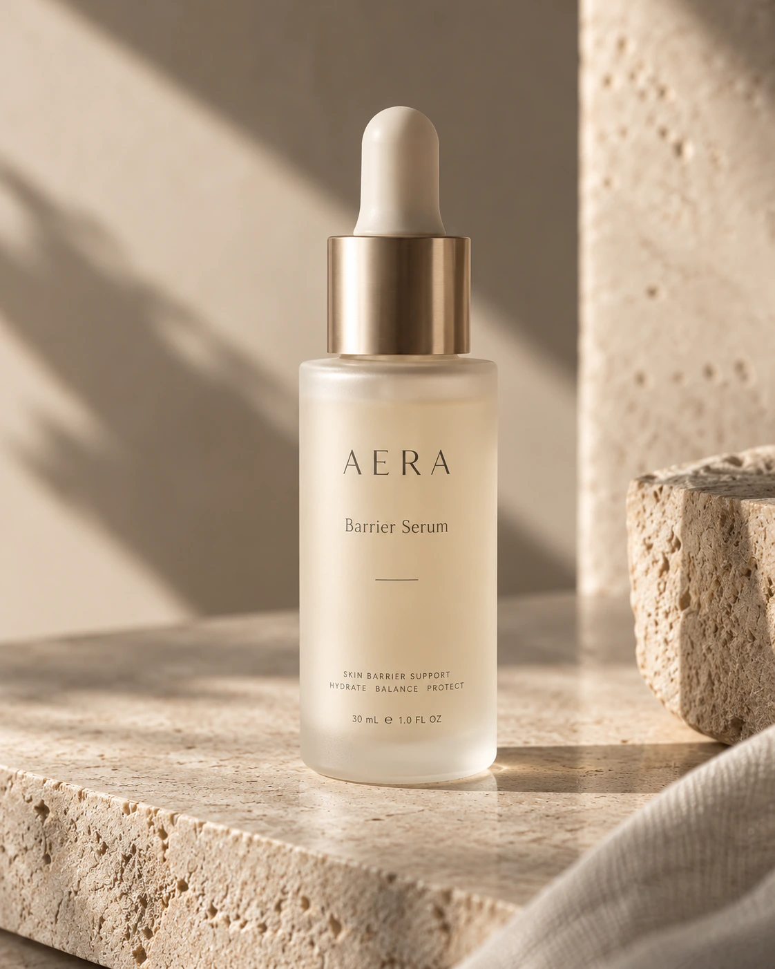 Unlabelled glass serum dropper bottle with golden serum on textured paper